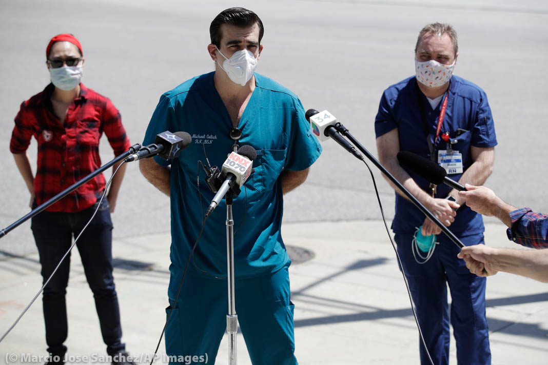 Three nurses standing near microphones (© Marcio Jose Sanchez/AP Images)